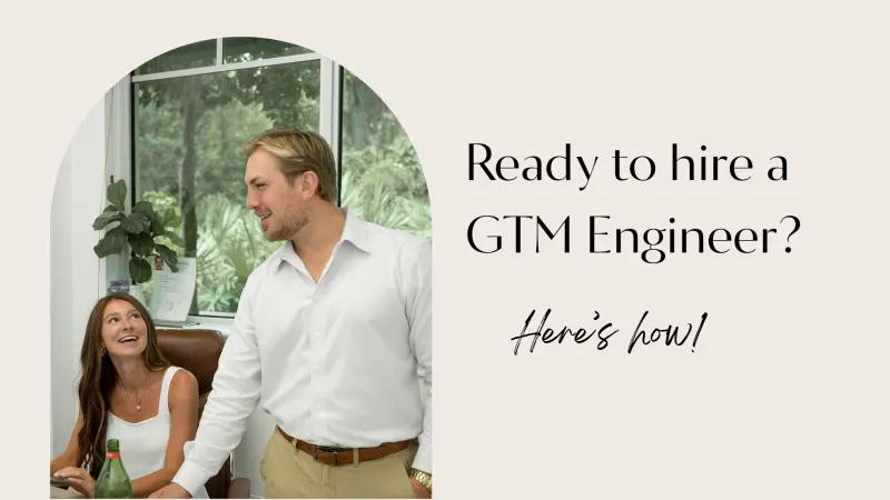 A man and a woman smile at each other in front of a window. Text reads: Ready to hire a GTM Engineer? Here’s how!