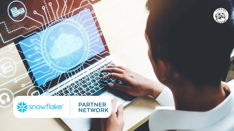 Man’s hands on a laptop with a cloud graphic on the screen; the Snowflake Partner Network logo is visible.