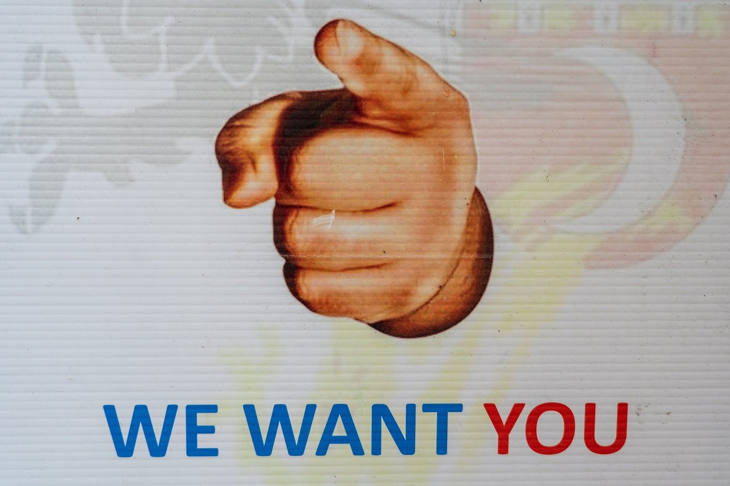 A hand points forward with the text WE WANT YOU below.